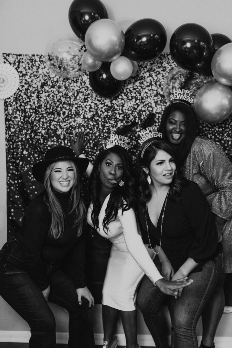 Group of friends posing together at a 360 photo booth event