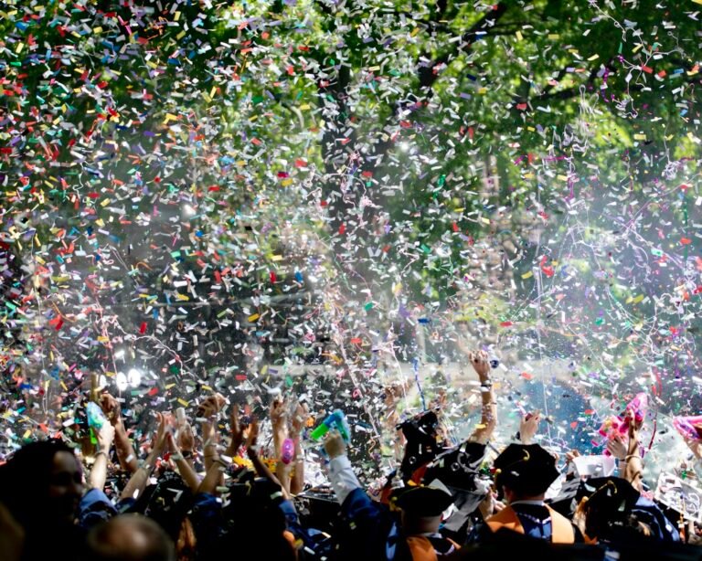 Graduation party guests covered in confetti