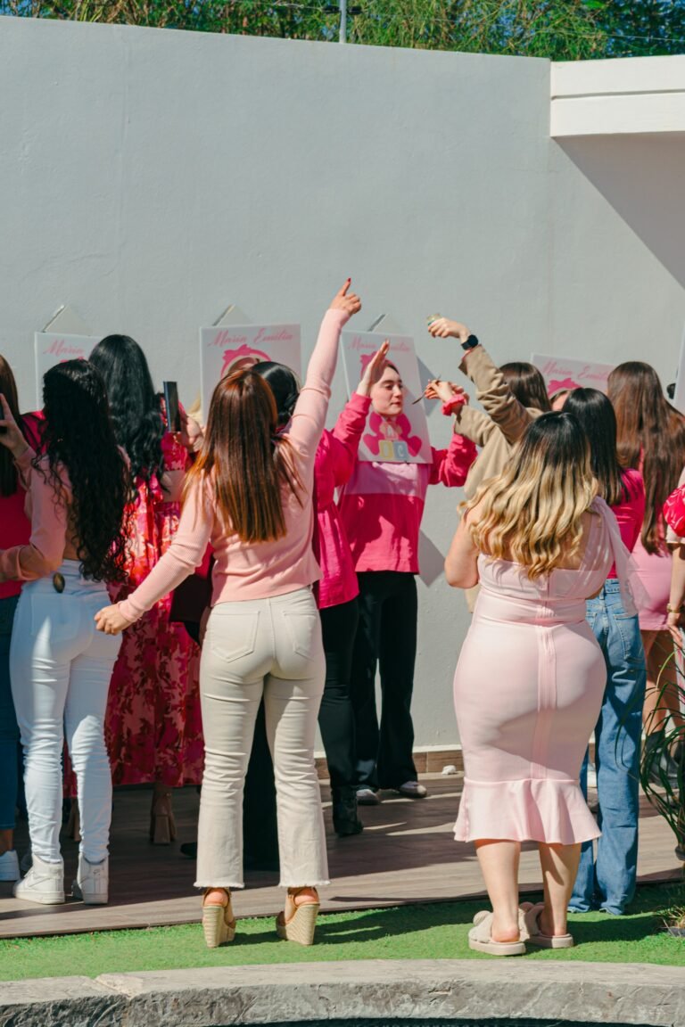 Women in pink dancing at a celebration